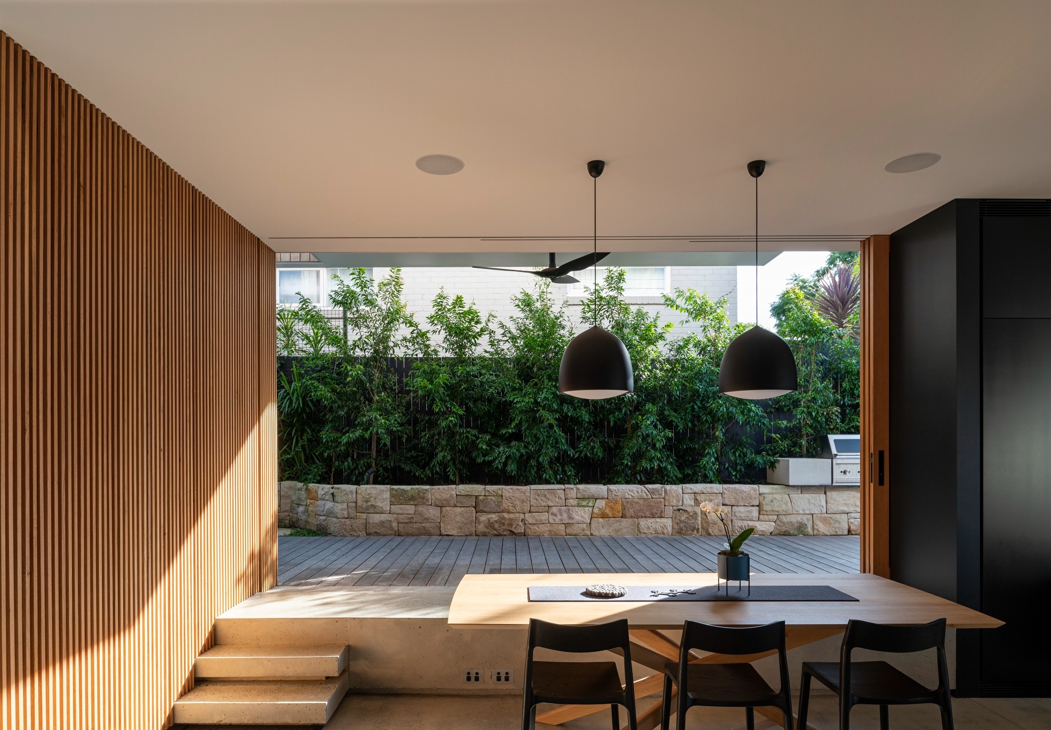 Modern Mosman garden design featuring layered coastal planting and refined stone pathways.