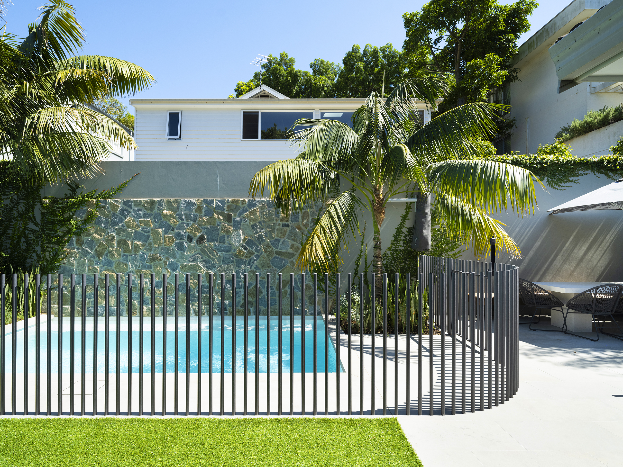 Elegant Bronte pool with minimal coping, crisp geometry, and soft layered planting.